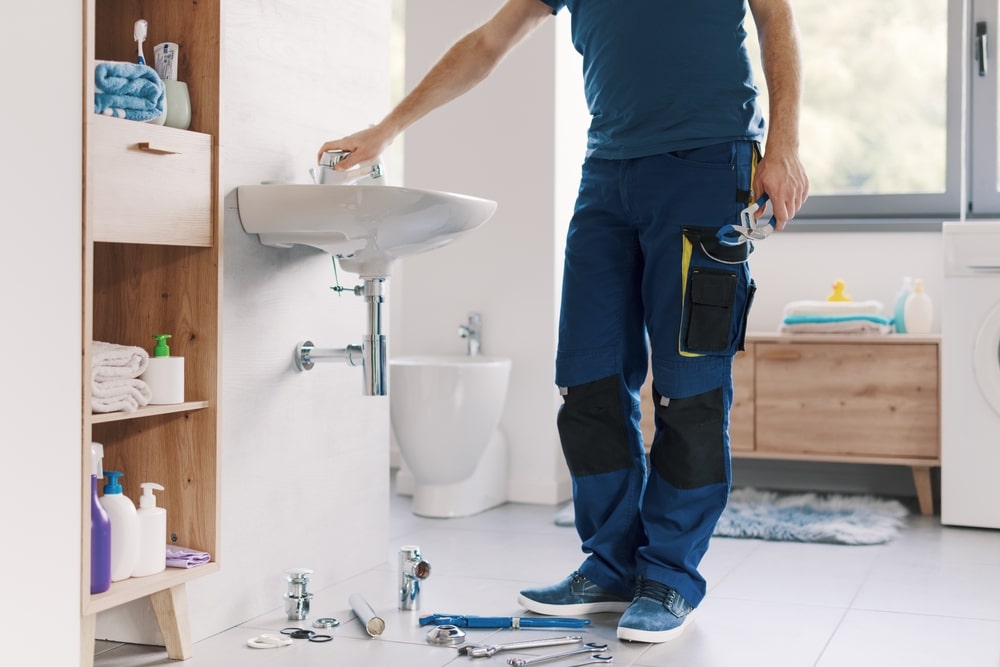 Plumber fixing sink