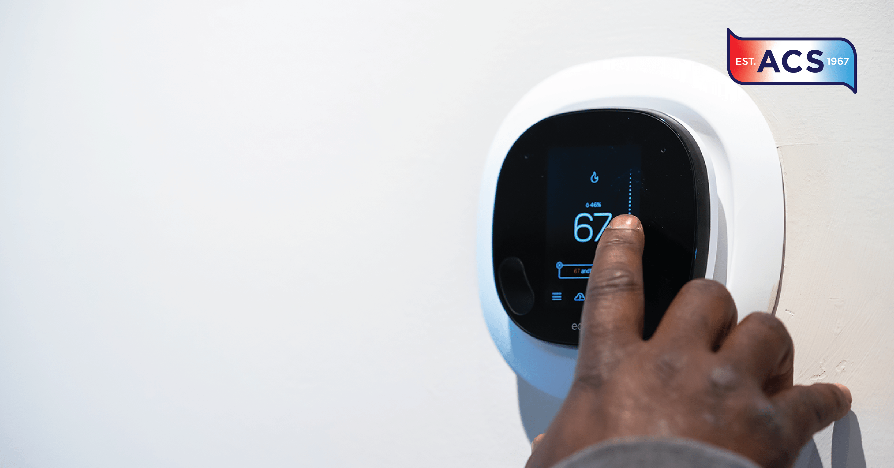 hand touching digital thermostat