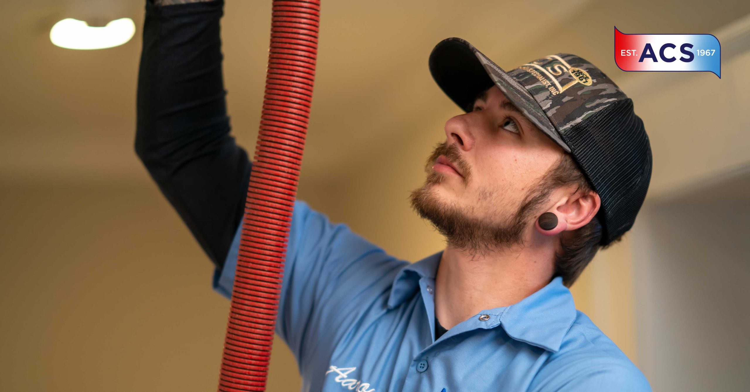 HVAC technician performing a dryer vent cleaning