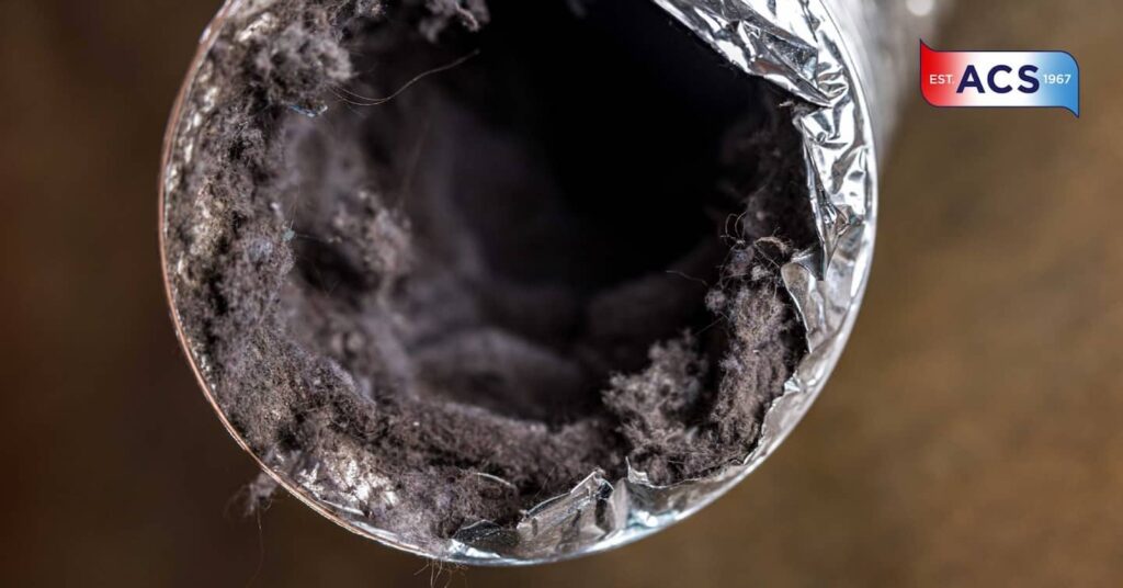 A dirty laundry aluminum dryer vent duct ductwork filled with lint, dust and dirt