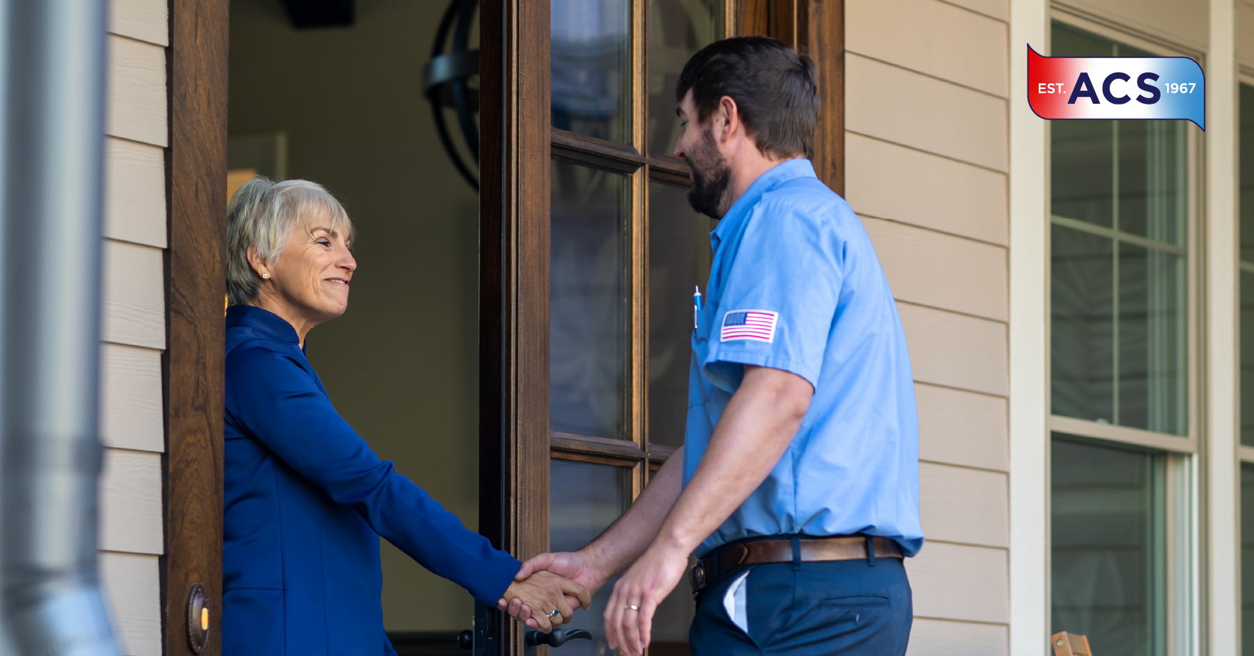 Male HVAC technician shaking hands with female homeowner
