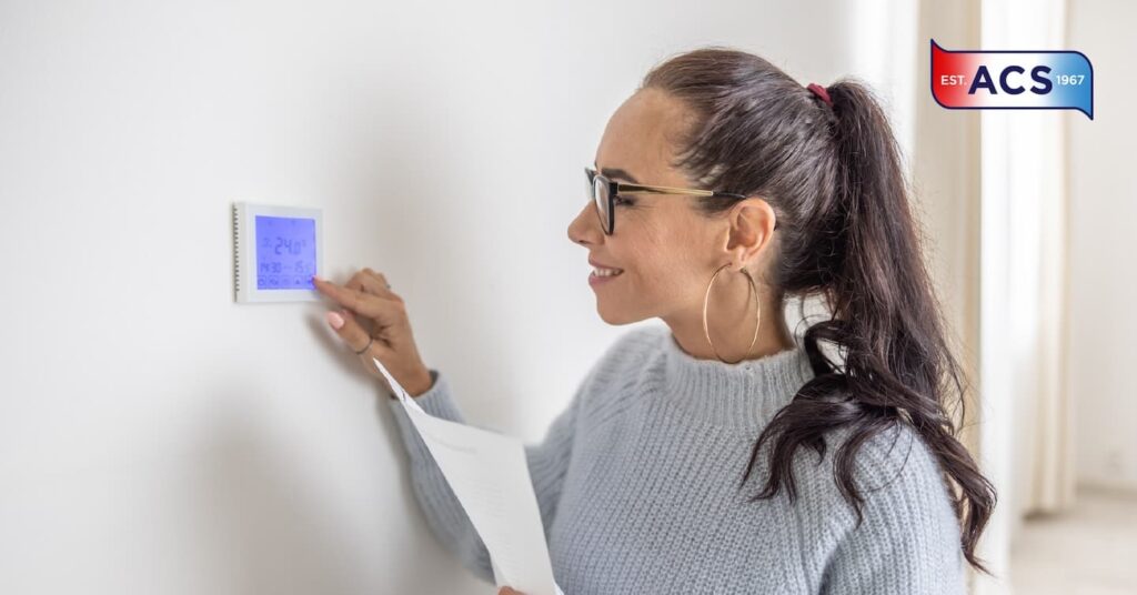 Woman Checking thermostat