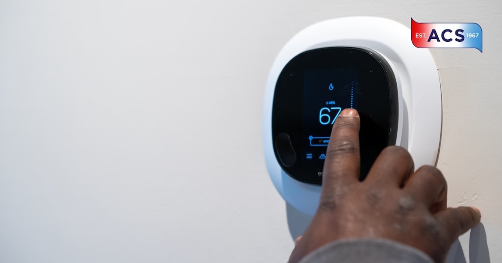 hand touching thermostat