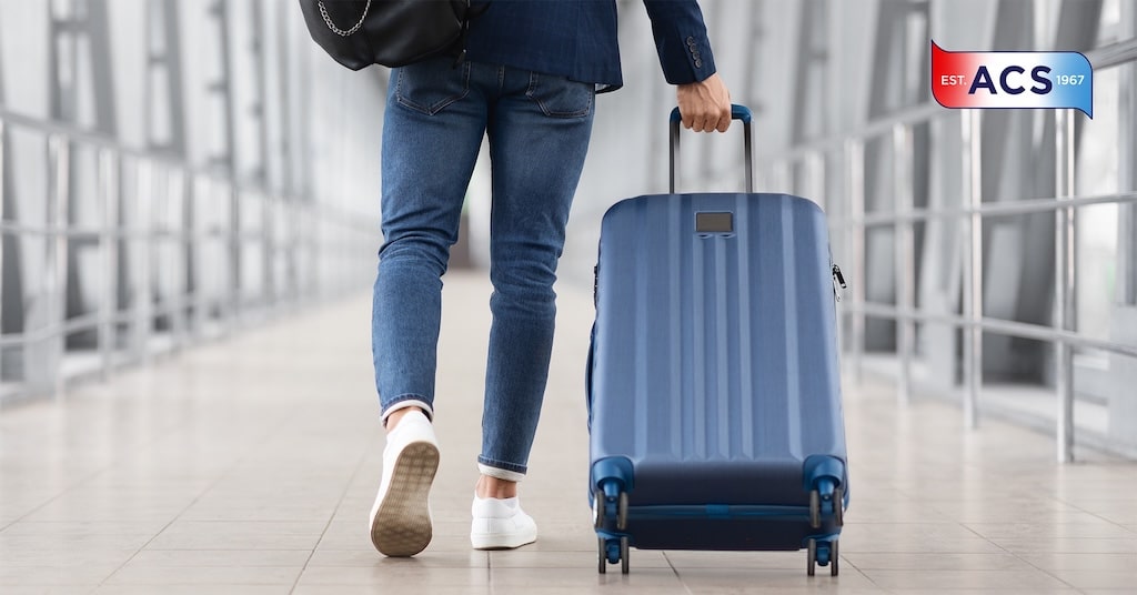 person pulling suitcase through airprot