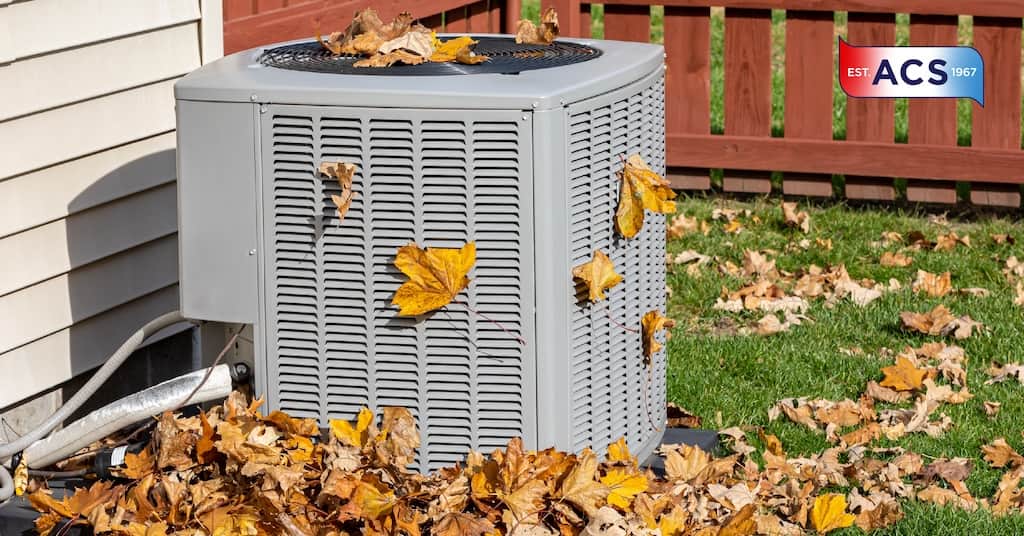 HVAC unit covered in Fall leaves