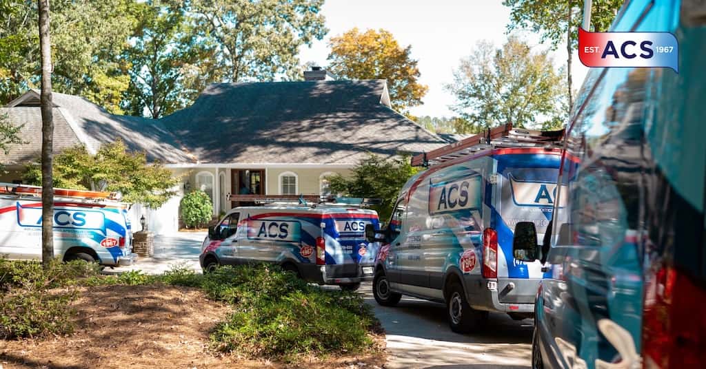 ACS HVAC vans parked outside of house