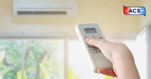 Hand holding remote control directed on the air conditioner testing air quality