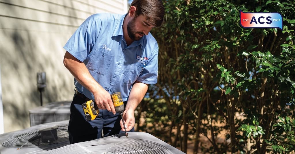 man repairing outside AC unit