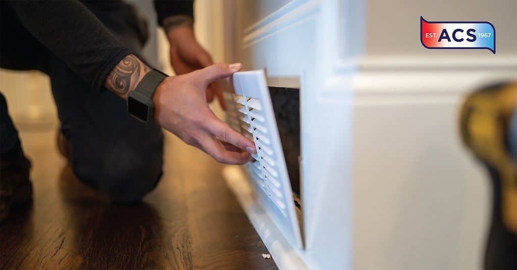 Man checking HVAC vent