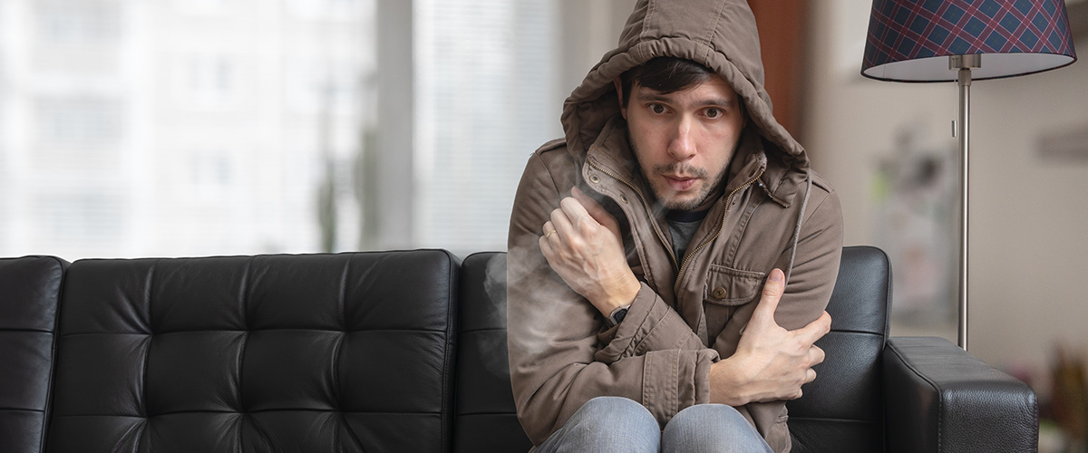 shivering man sitting on sofa