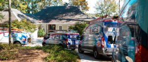 Complete Air Conditioning Specialist Guide - Air Conditioning Specialist service vans in front of residence.