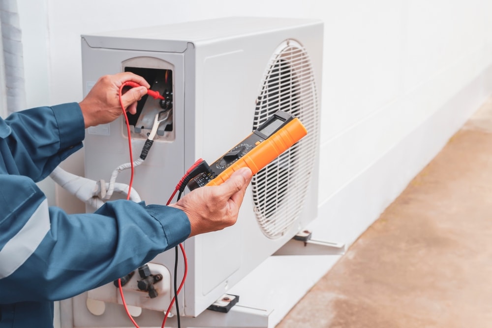 Air conditioner technician checking air conditioner operation